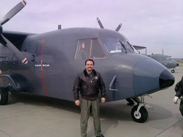 Aviation professional beside a military transport aircraft